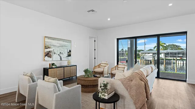 a living room with furniture and large windows