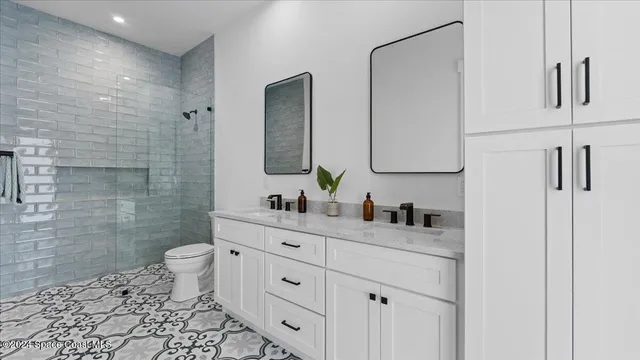a bathroom with a toilet sink and mirror