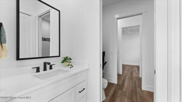 a bathroom with a sink a mirror and a shower