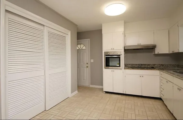 a kitchen with a cabinets and white appliances