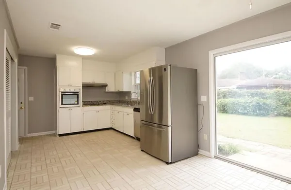 a kitchen with stainless steel appliances a refrigerator and a sink