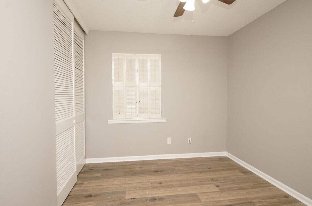 315 Sudduth Circle Northeast Fort Walton Beach, FL 32548 - Photo 16 of 30 an empty room with wooden floor cabinet and windows