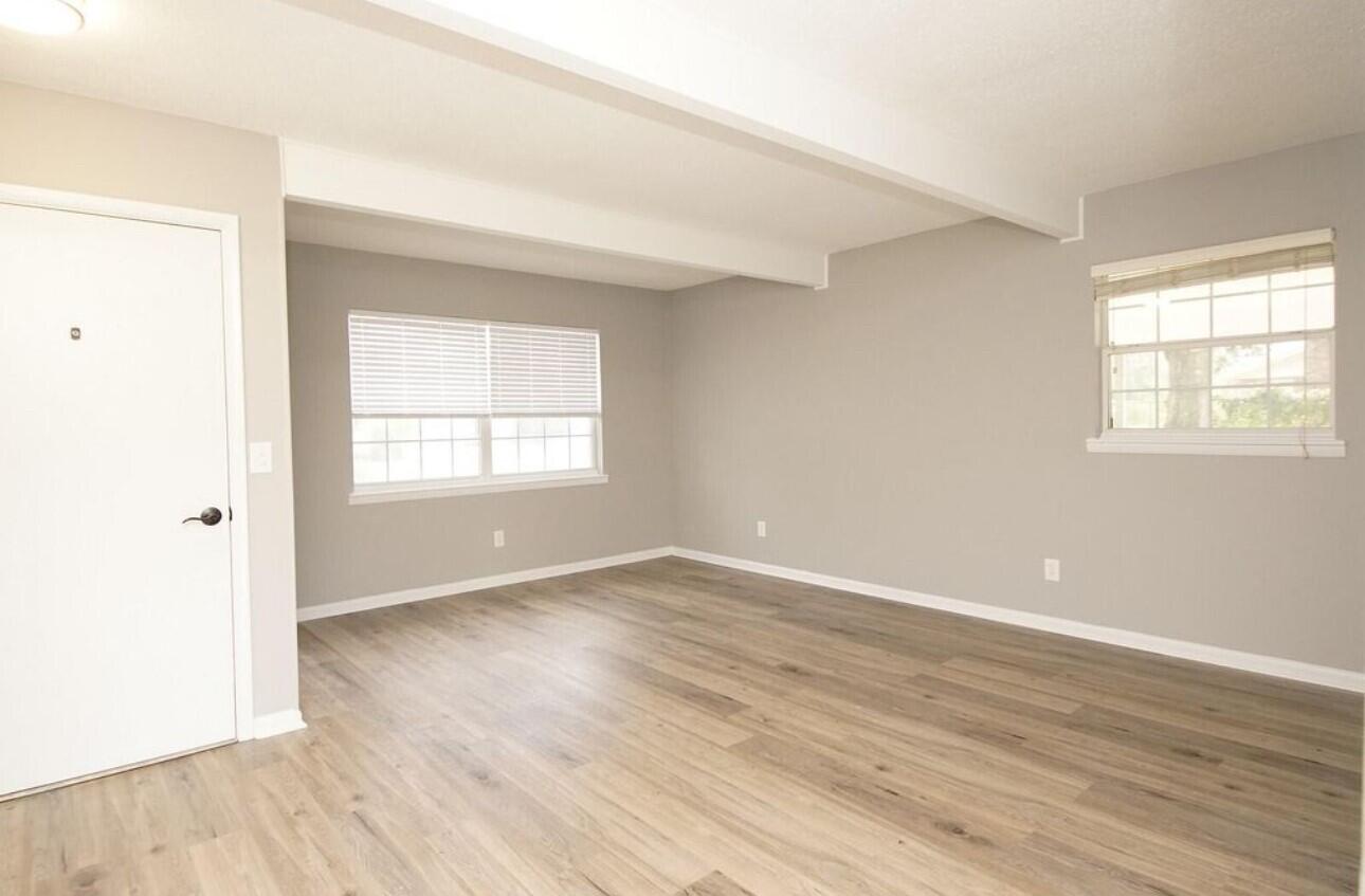 315 Sudduth Circle Northeast Fort Walton Beach, FL 32548 - Photo 23 of 30 an empty room with wooden floor and windows