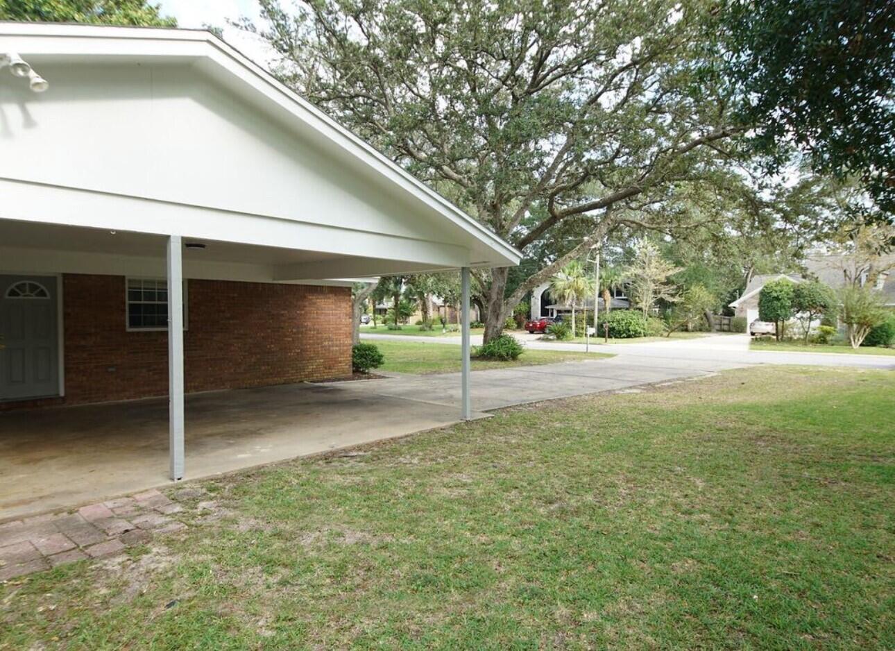 315 Sudduth Circle Northeast Fort Walton Beach, FL 32548 - Photo 28 of 30 a yellow house with trees in front of it