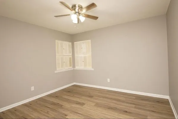 wooden floor in an empty room with a window