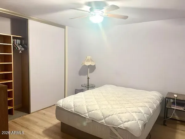 a bed sitting in a bedroom next to a window