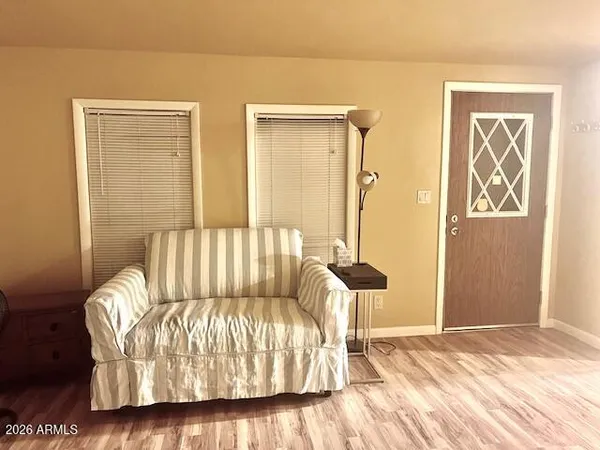 a view of a room with a wooden table and chairs