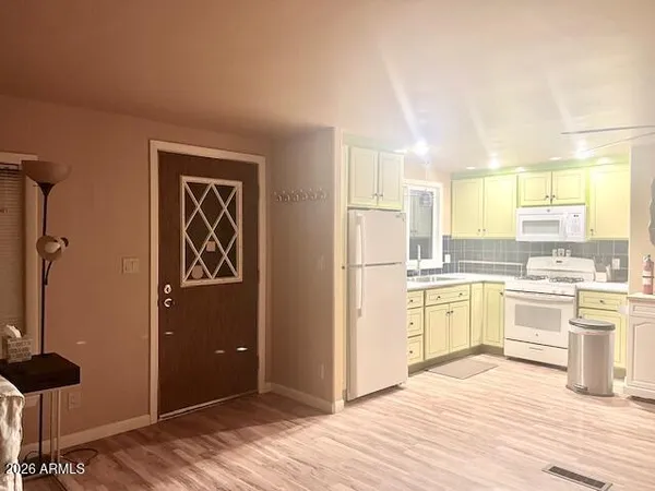 a kitchen with stainless steel appliances a refrigerator and wooden cabinets