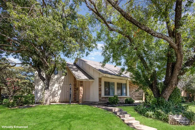 a front view of house with a garden