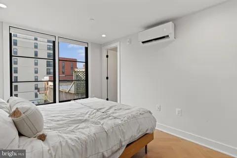 a bedroom with a bed and a window