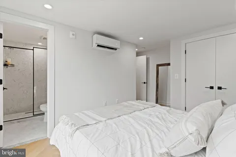 a bedroom with a bed and a walk in closet