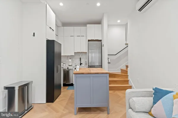 a kitchen with stainless steel appliances kitchen island granite countertop a refrigerator and a stove