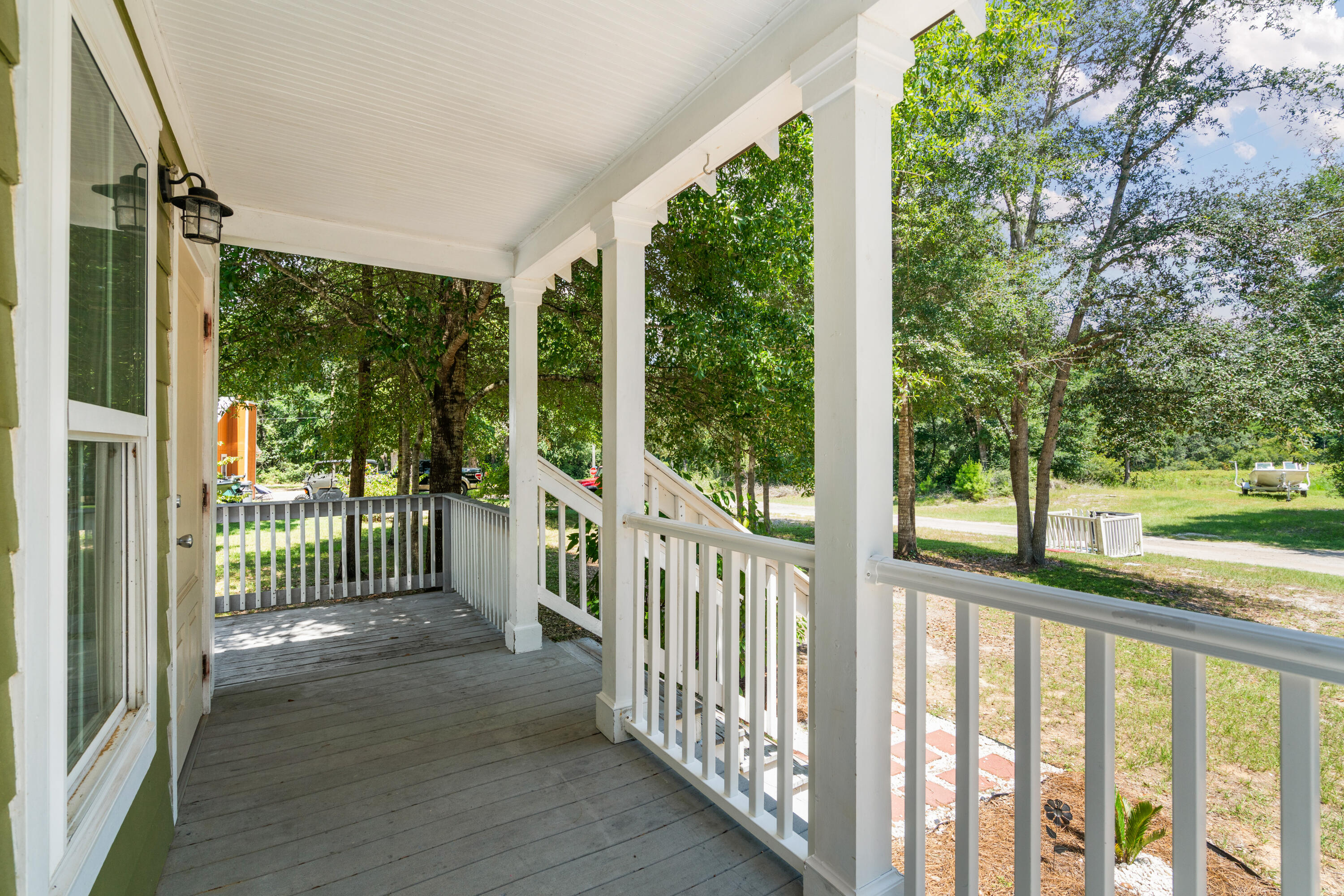 40 Horseshoe Lane Freeport, FL 32439 - Photo 3 of 16 a view of a porch with wooden floor and floor to ceiling window
