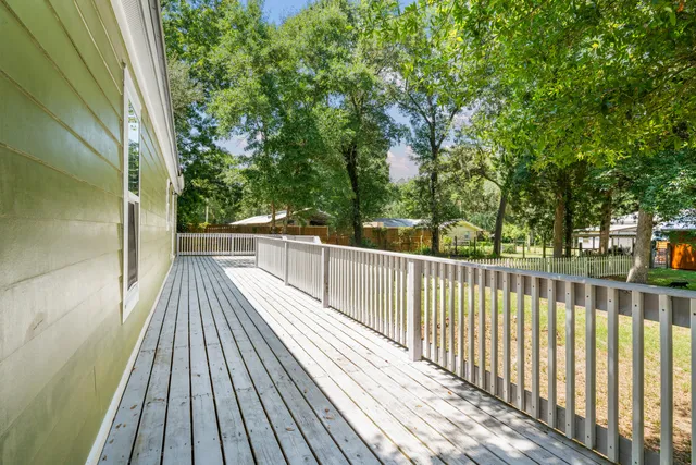 a view of balcony with wooden floor and fence