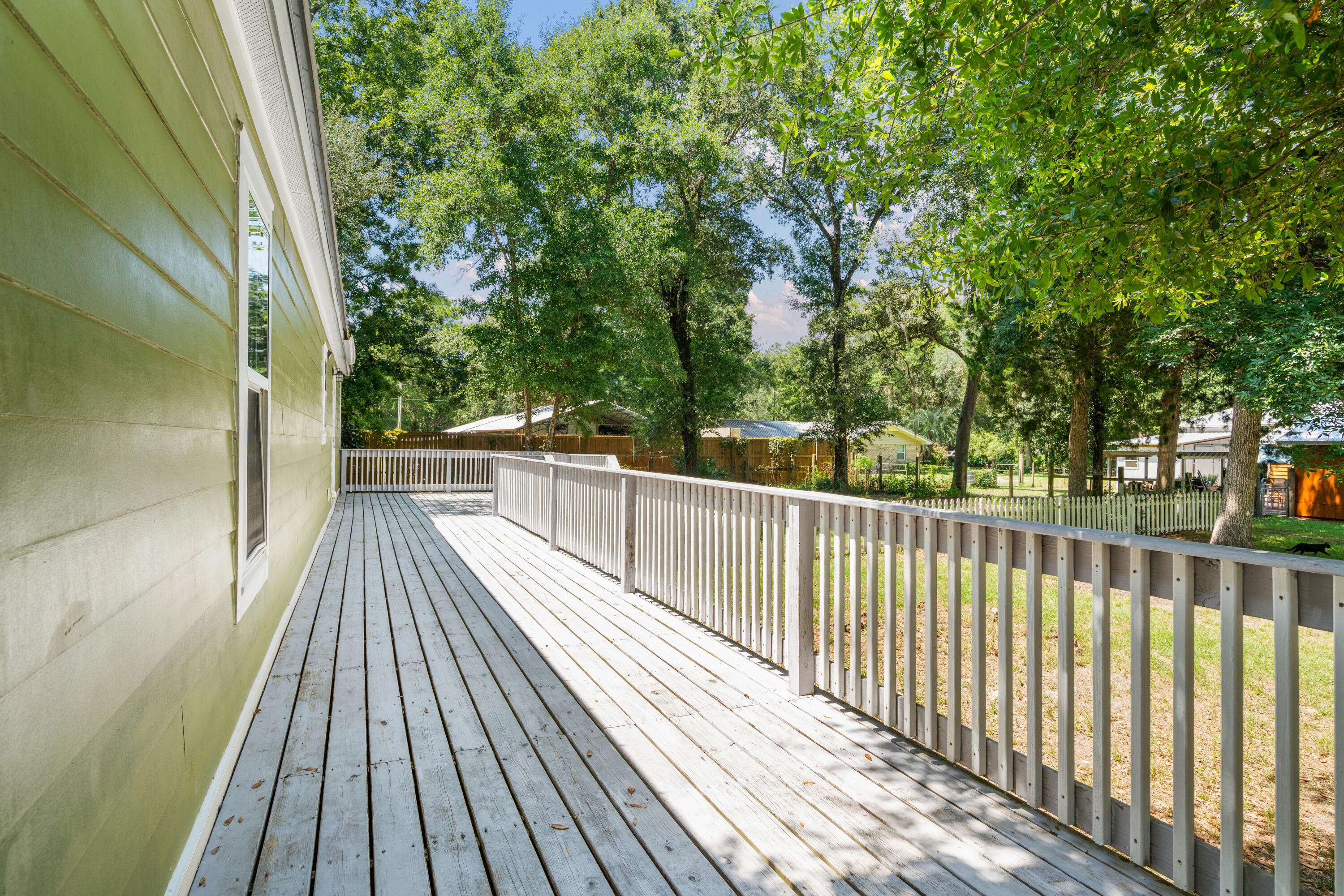 40 Horseshoe Lane Freeport, FL 32439 - Photo 4 of 16 a view of balcony with wooden floor and fence