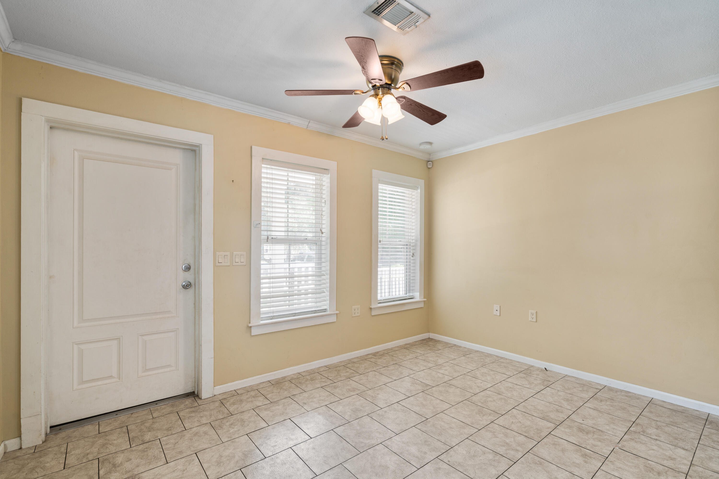 40 Horseshoe Lane Freeport, FL 32439 - Photo 5 of 16 an empty room with windows and fan