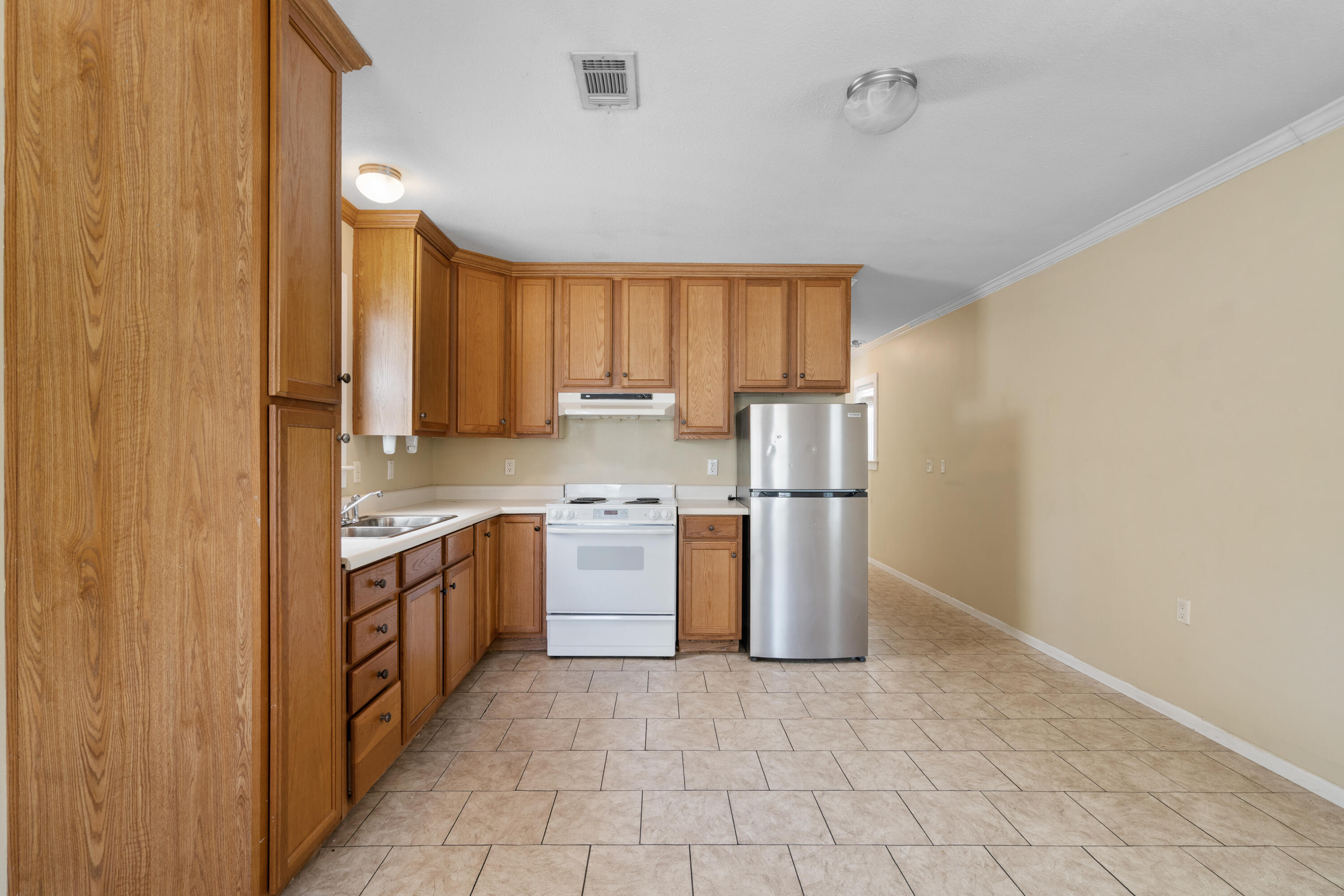 40 Horseshoe Lane Freeport, FL 32439 - Photo 6 of 16 a kitchen with stainless steel appliances granite countertop a stove a sink and a refrigerator