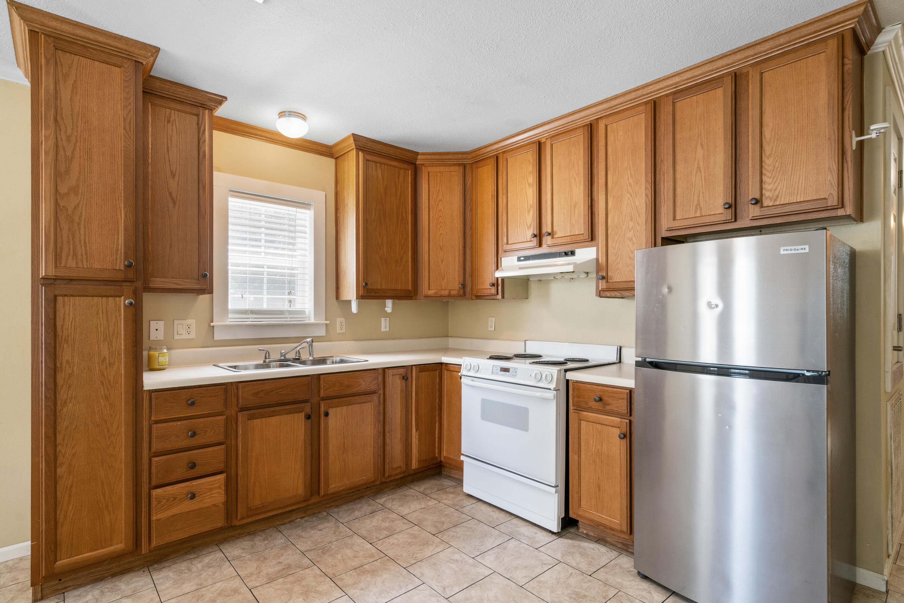 40 Horseshoe Lane Freeport, FL 32439 - Photo 7 of 16 a kitchen with stainless steel appliances granite countertop a refrigerator sink and cabinets