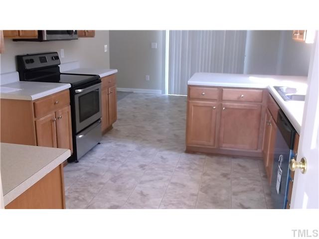 5417 Glass Ridge Road Raleigh, NC 27616 - Photo 3 of 14 a kitchen with a stove and a microwave