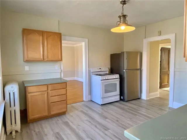 a kitchen with stainless steel appliances a refrigerator and a stove top oven