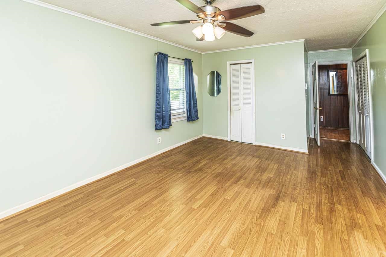 725 Old Brownsville Road Ripley, TN 38063 - Photo 14 of 40 a view of a big room with wooden floor and windows