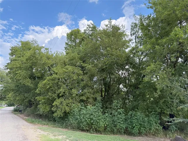an aerial view of a houses with yard