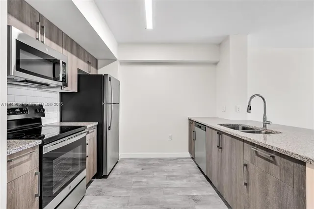 a kitchen with stainless steel appliances a refrigerator stove and sink