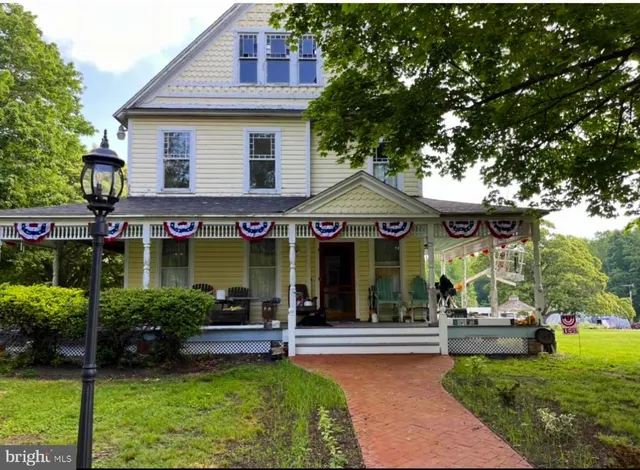 a view of a house with sitting area and a yard