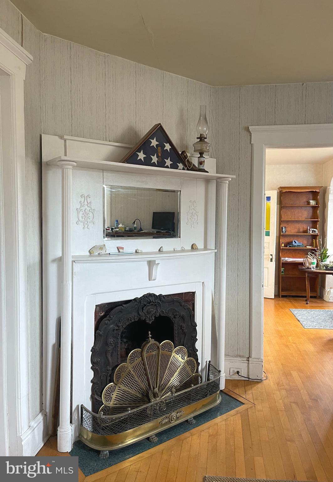 6310 St Leonard Road St. Leonard, MD 20685 - Photo 15 of 26 a living room with a fireplace and a flat screen tv