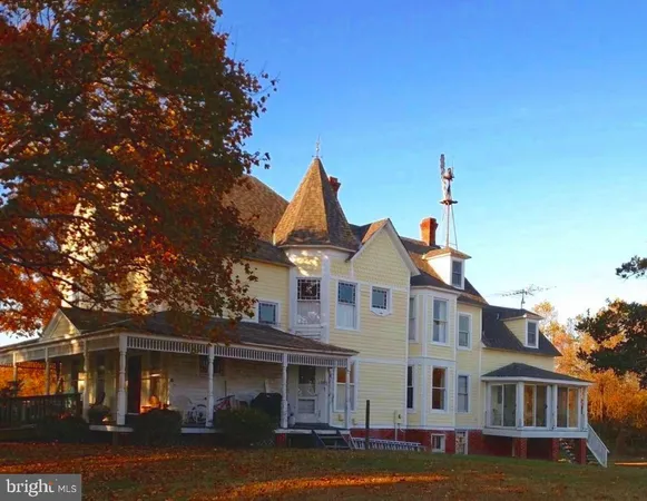front view of a brick house with a yard
