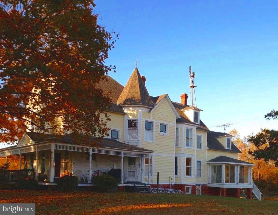6310 St Leonard Road St. Leonard, MD 20685 - Photo 2 of 16 front view of a brick house with a yard