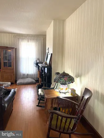 a view of a workspace with furniture and a window