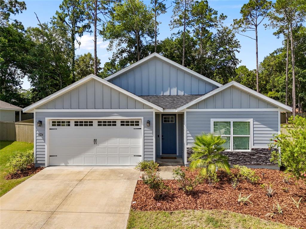 1767 Southwest 67th Circle Gainesville, FL 32607 - Photo 1 of 1 a view of a house with yard and plants