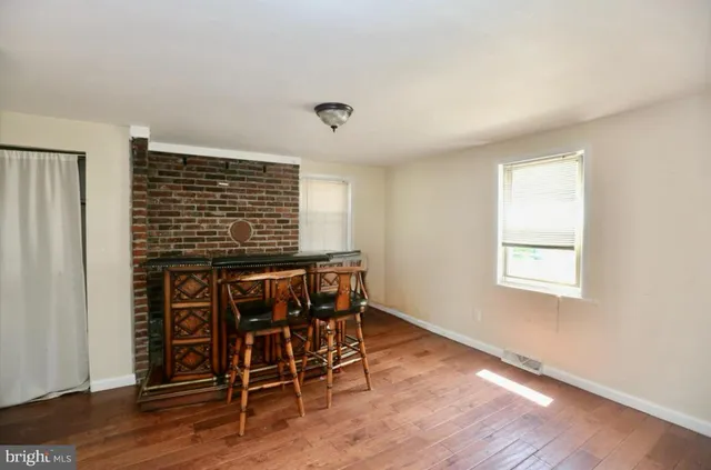 a view of a livingroom with furniture and wooden floor