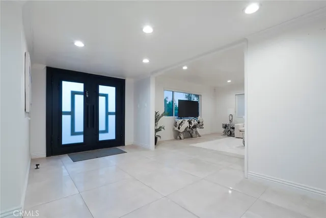 a view of a livingroom with a couch and a flat screen tv