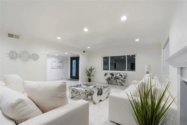 a living room with furniture a large window and a flat screen tv