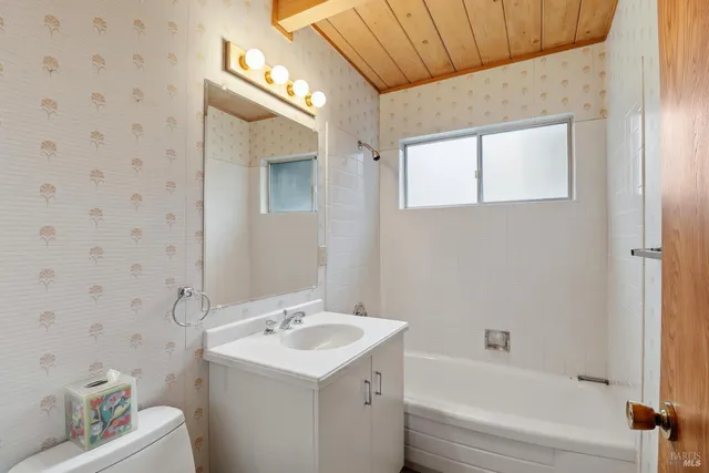 a view of a pathway with a flower garden