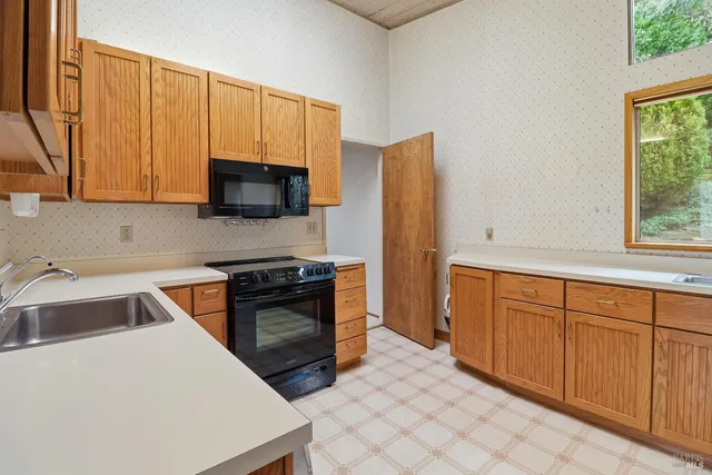 a kitchen with stainless steel appliances a refrigerator sink and cabinets