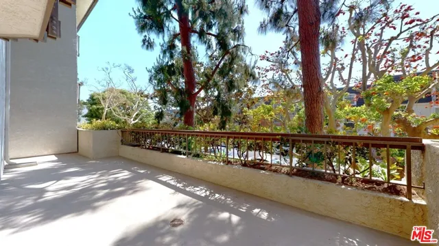 a view of a balcony with wooden fence