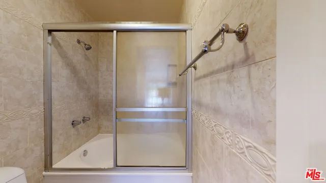 a bathroom with a glass shower door