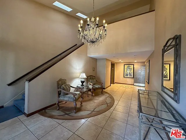 a view of a dining room with furniture and chandelier