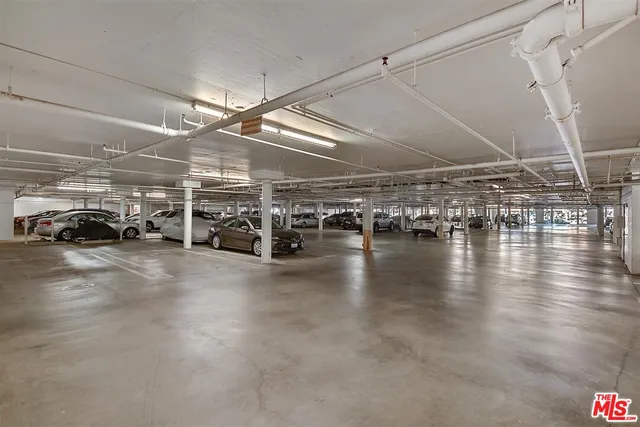 a view of parking space with parked cars