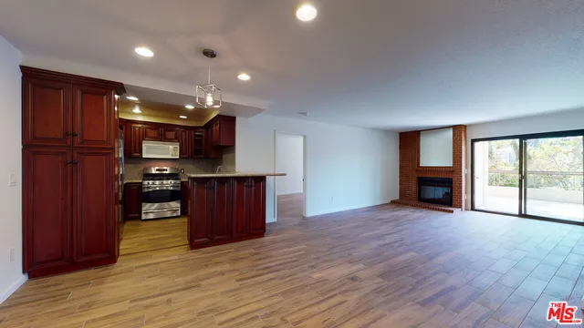 a view of kitchen with cabinets and wooden floor