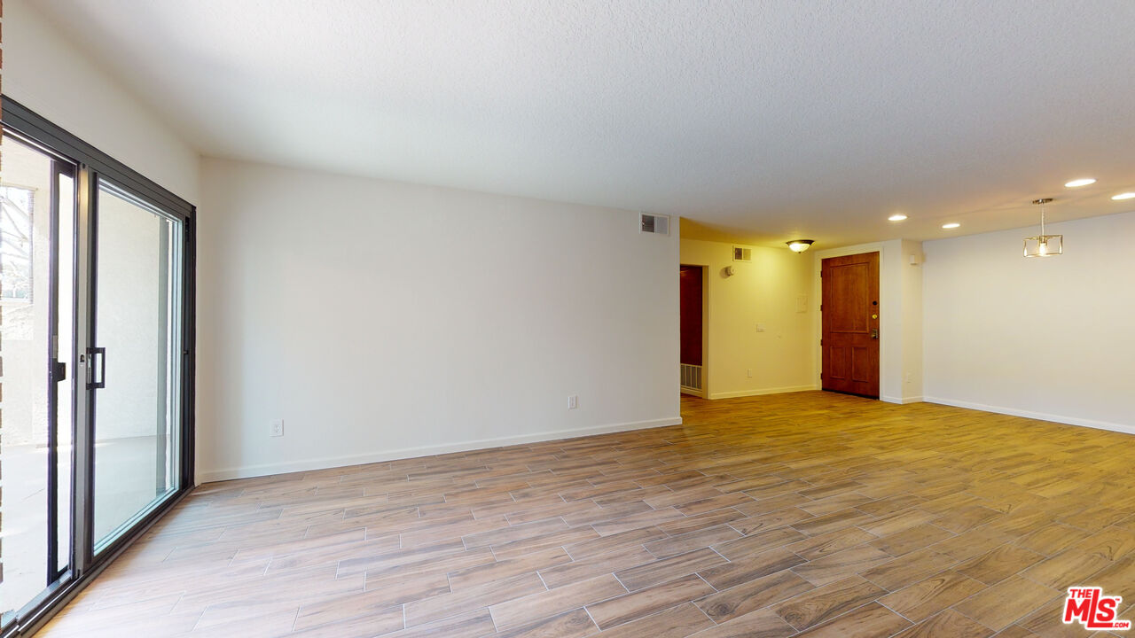 8600 Tuscany Avenue, Unit 202 Playa del Rey, CA 90293 - Photo 8 of 29 a view of an empty room with wooden floor and a window