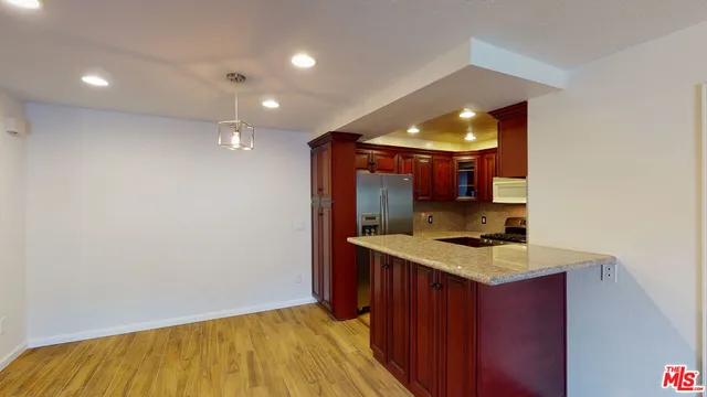 a kitchen with a sink and a mirror