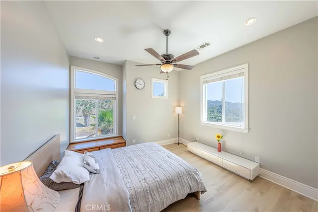a bathroom with a granite countertop sink a large mirror and a shower