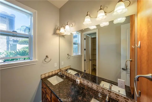 a bathroom with a granite countertop bathtub next to a toilet