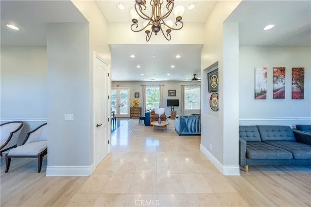 a view of a hallway with furniture and a livingroom