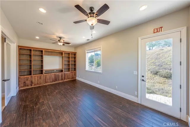 a view of a hallway with furniture and windows