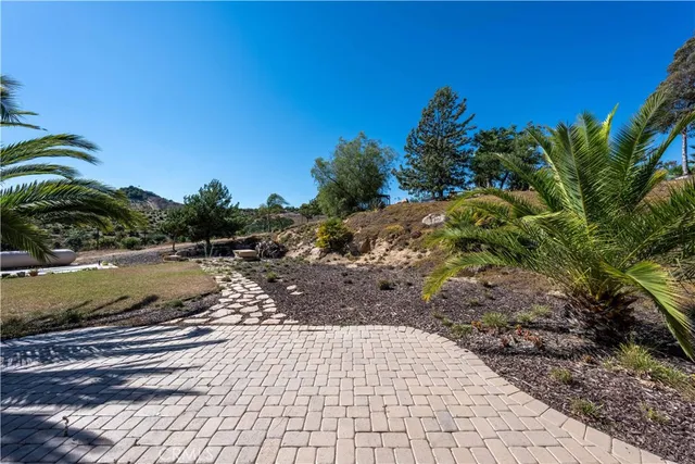 a view of a yard with wooden fence